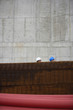 Two men at construction site behind stack of rebar