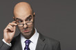 Balding businessman hand on glasses, making a face