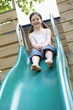 Little girl on top of slippery slide, portrait