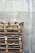 Stack of pallets against concrete wall