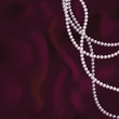 Pink pearls on a dark red silk