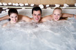 One man with two woman in jacuzzi at a spa One man with two woman in jacuzzi at a spa