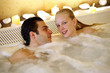 One man with two woman  in jacuzzi at a spa