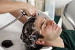 Young man having his hair  washed at a salon