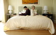Mature couple working in bed