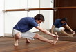 Young man stretching in gym