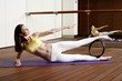 Young woman performing a pilates exercise