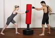 Young man and woman practicing with a punching bag