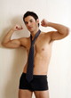 Bare chested young man posing with shorts and tie