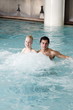 Young couple swimming in spa pool