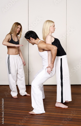 Photo: Partners practicing flexibility in yoga and Capoeira programs Partners practicing flexibility in yoga and Capoeira programs