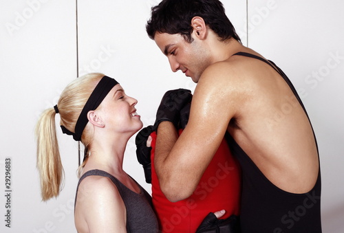 Photo: Young man and woman flirting in a fitness class Young man and woman flirting in a fitness class