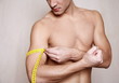 Man measuring his arm muscle