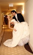 Groom carrying bride into hotel room