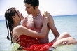 Man holding woman in the water