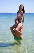 Young woman sitting on man's shoulders