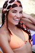 Young woman with scarf on beach