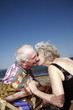 Senior couple with on beach kissing