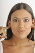 "Female young adult;plugging ears with fingers"