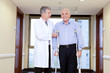 Doctor helping a disabled senior