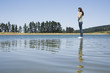 Profile of woman standing on water praying