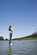 Profile of woman standing on water praying