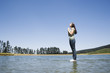 Profile of woman standing on water praying