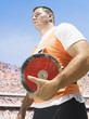 Athlete with discus in arena