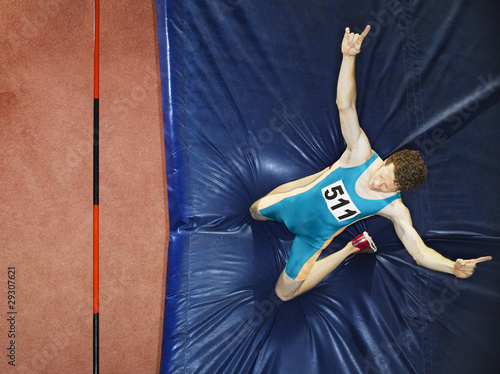 Photo: Athlete on a crash mat after high jumping Athlete on a crash mat after high jumping