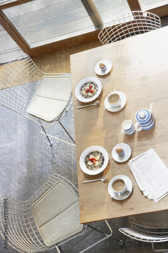 Photo: Breakfast and a newspaper on a kitchen table Breakfast and a newspaper on a kitchen table