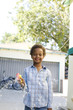 Boy standing in driveway with toy bubble gun