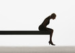 Woman sitting on a plank looking over ledge
