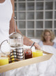 Man bringing woman breakfast in bed