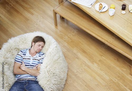 Photo: Man on a furry bean bag chair wearing earbuds Man on a furry bean bag chair wearing earbuds