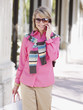 Woman outdoors with shopping bags and her mobile phone