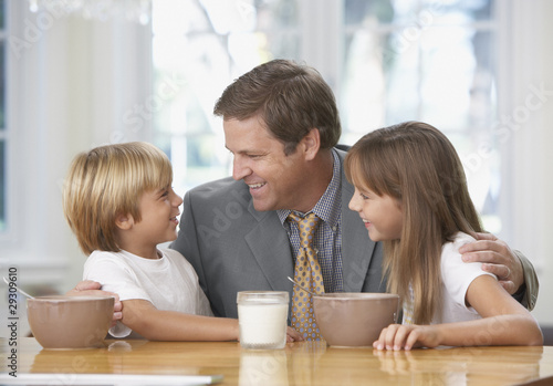 Photo: Man and two young kids in kitchen bonding Man and two young kids in kitchen bonding