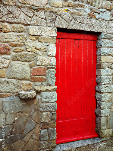 Photo: Red door with antique stone hitching post Red door with antique stone hitching post