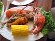 Dish crabs with corn, fish, a hen and greens