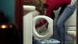 woman using washing machine, doing chores