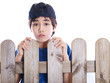 child looking over a fence