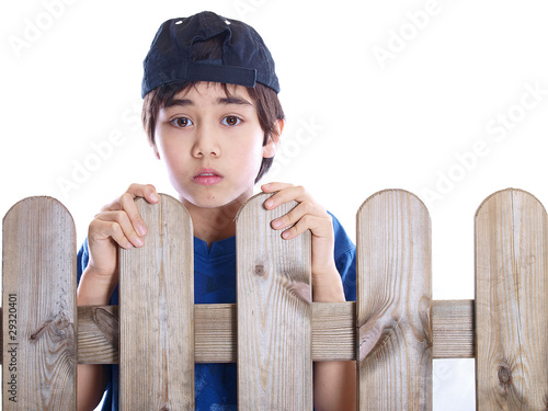 Photo: child looking over a fence child looking over a fence