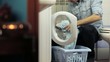 man using washing machine, doing chores
