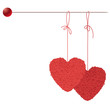 Two balls of threads in the form of heart hanging on a spoke