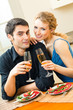 Young happy amorous couple celebrating with champagne Young happy amorous couple celebrating with champagne