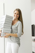 Portrait of a woman carrying shoe boxes