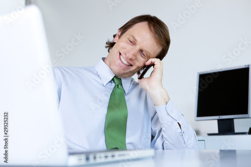 Photo: Young businessman calling by phone Young businessman calling by phone
