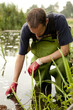 Photo: Taking water and mud samples. Taking water and mud samples.