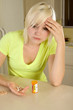Young blond woman with medicine pills