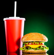 Tasty and appetizing hamburger on a darkly green Tasty and appetizing hamburger on a darkly green