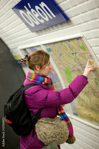 Photo: Tourist girl in Parisian metro, looking at the map Tourist girl in Parisian metro, looking at the map